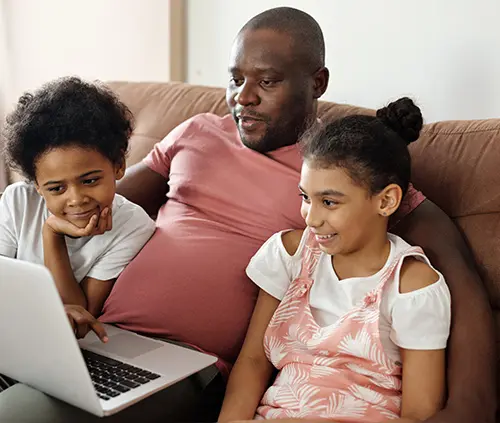 padre con hijos mirando el ordenador