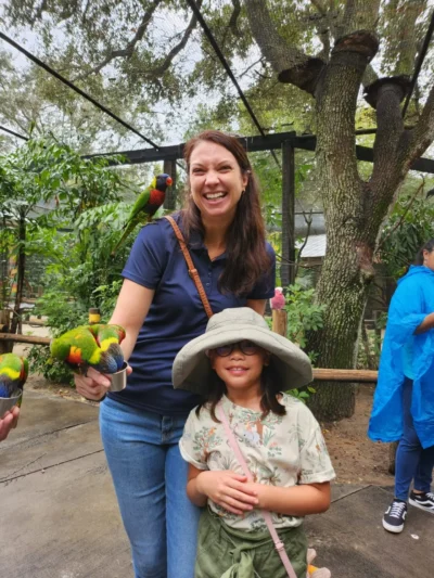Mujer con loros y niña